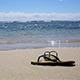 Sandals On The Sand Of The Beach During The Summer